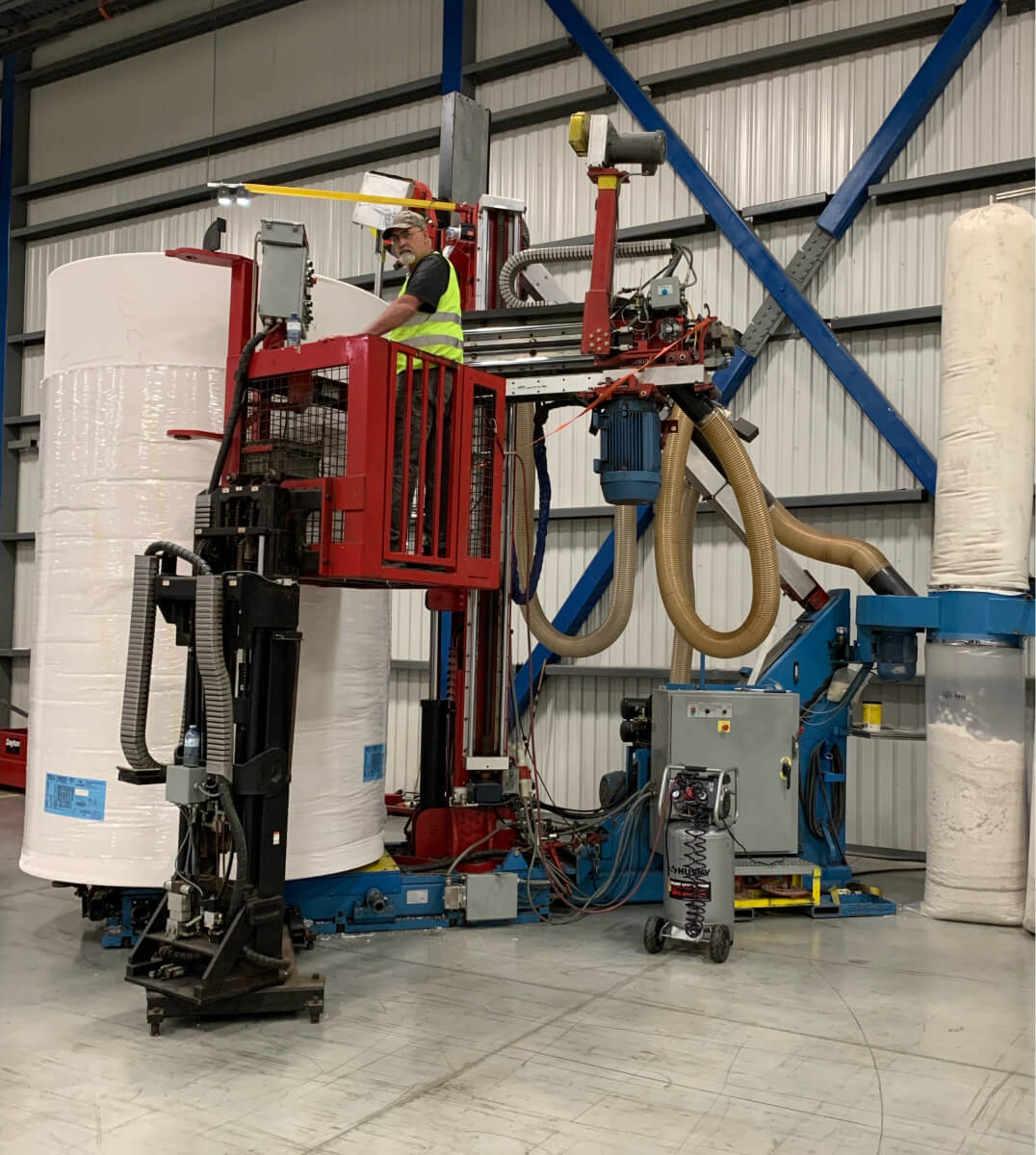 Fibercore's plunge-cutter converting a large parent paper roll on the facility floor